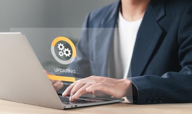 Person using laptop with hovering loading screen