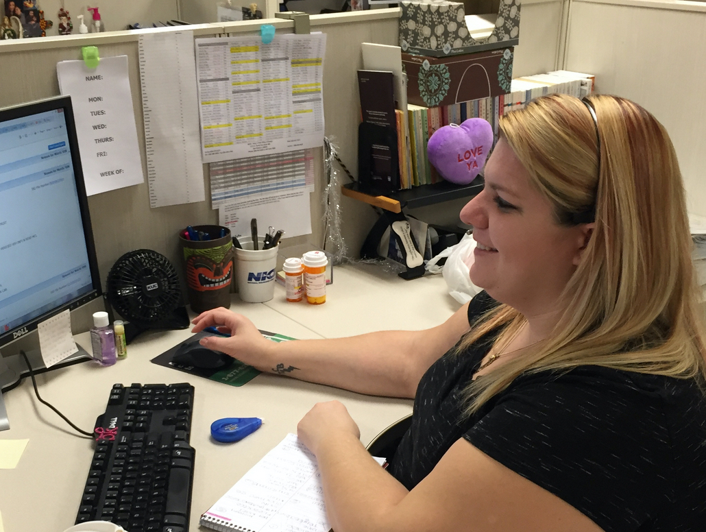 An NICB employee at her desk