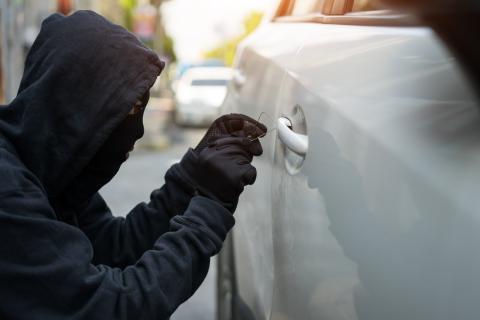 Person attempting to break into a vehicle