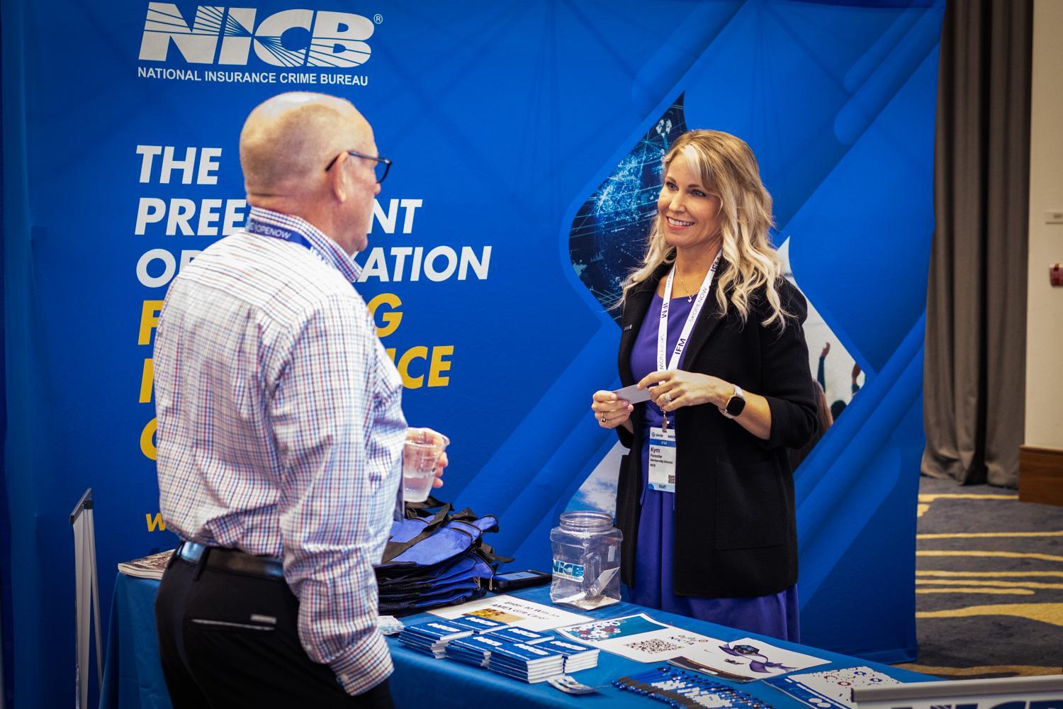 NICB's Kym Forester speaking at an NICB booth